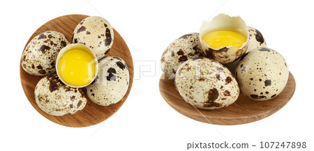 Raw quail egg in wooden bowl isolated on white background with full depth of field. Top view. Flat lay Raw quail egg in wooden bowl isolated on white background with full depth of field. Top view. Flat lay 107247898