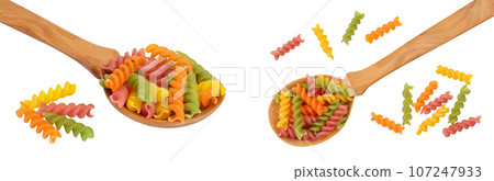 raw Fusilli colored pasta in wooden spoon isolated on white background with full depth of field. Top view. Flat lay 107247933