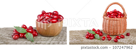 dogwood berry with leaf in bowl on wooden table with white background 107247962