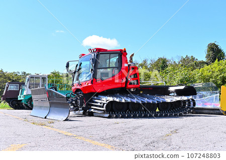 Snow compaction vehicles waiting for the season, ski slopes, Tambara Ski Park 107248803