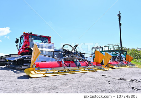 Snow compaction vehicles waiting for the season, ski slopes, Tambara Ski Park 107248805
