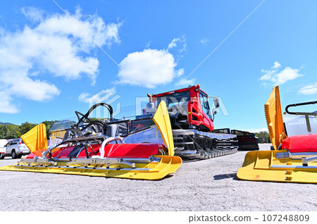 Snow compaction vehicles waiting for the season, ski slopes, Tambara Ski Park 107248809