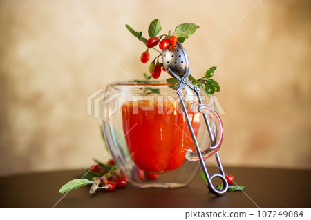 Prepared hot drink from ripe goji berries in a glass cup Prepared hot drink from ripe goji berries in a glass cup 107249084
