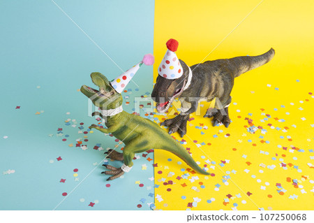 a pair of dinosaurs celebrating on a confetti carpet a pair of dinosaurs celebrating on a confetti carpet 107250068