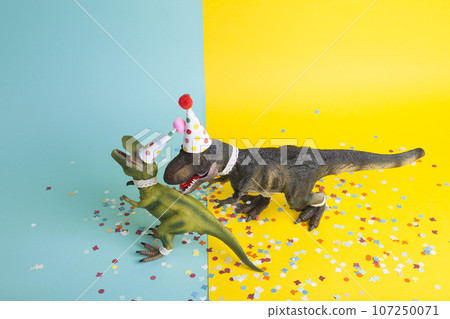 a pair of dinosaurs celebrating on a confetti carpet 107250071