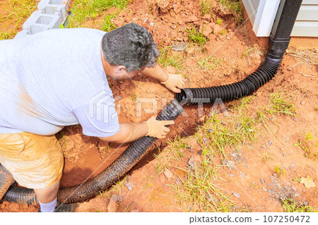Drainage pipe connector downspout installation for flexible gutter extension with water draining down 107250472