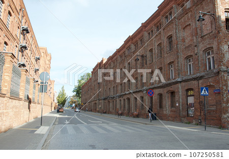 Unredeveloped red brick buildings in the Manufaktura neighborhood in Lodz, Poland's third largest city 107250581