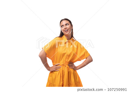 young caucasian brunette woman with long hair dressed in yellow summer dress on vacation young caucasian brunette woman with long hair dressed in yellow summer dress on vacation 107250991