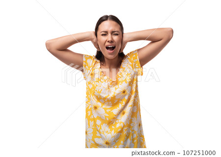 close-up portrait of a young caucasian woman in a yellow summer t-shirt with closed ears and 107251000