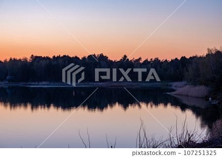 Majestic Dusk Sky Reflecting Over Tranquil Forest Lake Majestic Dusk Sky Reflecting Over Tranquil Forest Lake 107251325