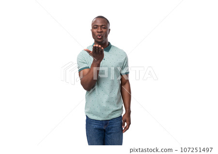 young friendly charming short-haired american man dressed in a summer t-shirt and jeans on a white young friendly charming short-haired american man dressed in a summer t-shirt and jeans on a white 107251497