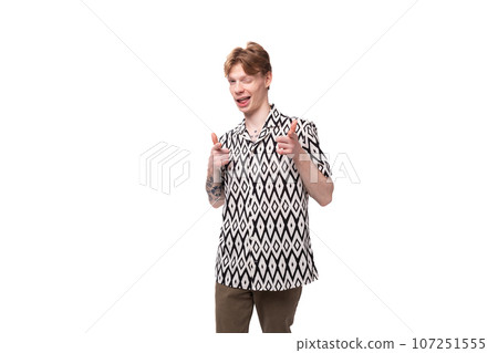 young red-haired man in a summer shirt with a rhombus print on a background with copy space 107251555
