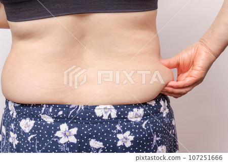 [Back view of a housewife picking meat from her side] 107251666