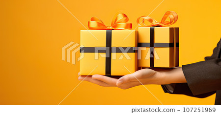 Hands holding gift boxes for black friday on yellow background. Concept of sales, black friday, cyber monday, finance, business, money. Online shops and payments bill. Copyspace for ad 107251969