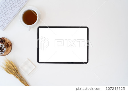 Modern desk workspace with blank copy space mockup with blank screen tablet, coffee cup, technology, headphones with equipment other office top view freelance business concept for social media Modern desk workspace with blank copy space mockup with blank screen tablet, coffee cup, technology, headphones with equipment other office top view freelance business concept for social media 107252325