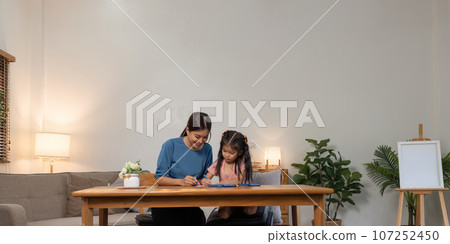 Mother and her daughter draw in the paper together, Leisure activities, holiday 107252450