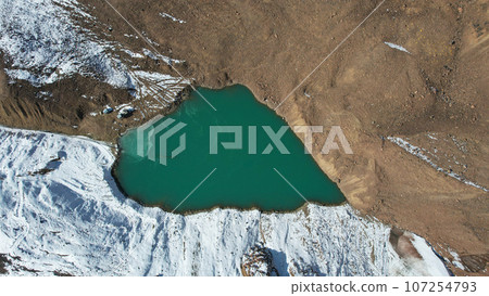 A mountain lake with emerald water is like mirror A mountain lake with emerald water is like mirror 107254793