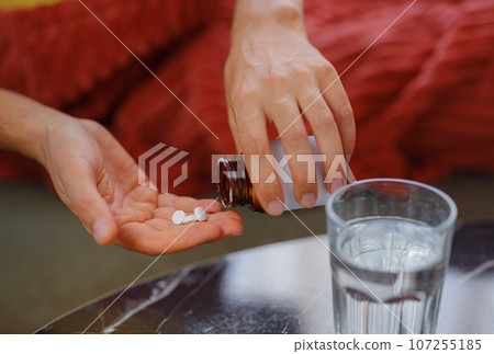 adult sick ill man hold pills on hand pouring capsules from medication bottle, take painkiller supplement medicine, people pharmaceutical healthcare treatment concept, close up view at home adult sick ill man hold pills on hand pouring capsules from medication bottle, take painkiller supplement medicine, people pharmaceutical healthcare treatment concept, close up view at home 107255185