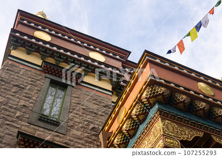 fragment of the facade of a Buddhist datsan Gunzechoinei building with traditional elements 107255293