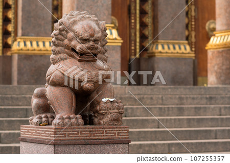stone statue of a lion at the entrance to the Buddhist datsan Gunzechoinei stone statue of a lion at the entrance to the Buddhist datsan Gunzechoinei 107255357