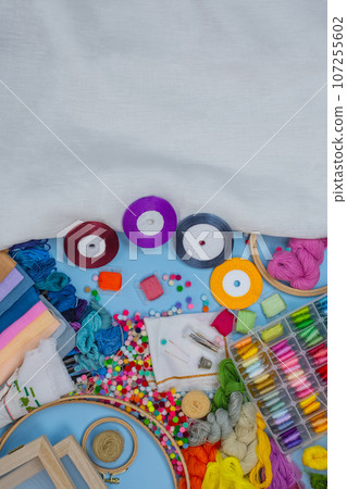 Set of satin ribbons of different colors close up. Hand embroidery with satin ribbons. 107255602