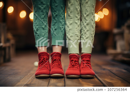 Children's feet in warm boots and woolen tights Children's feet in warm boots and woolen tights 107256364