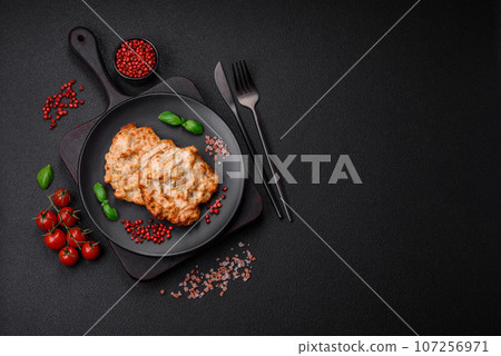 Delicious fried chicken chop or pork meat fried breaded with salt, spices and herbs 107256971