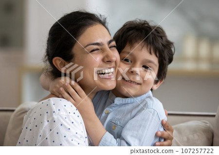 Head shot excited Indian mother hugging adorable 5s son 107257722