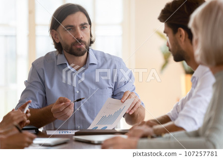 Businessman gives presentation for staff analyzing company financial report Businessman gives presentation for staff analyzing company financial report 107257781