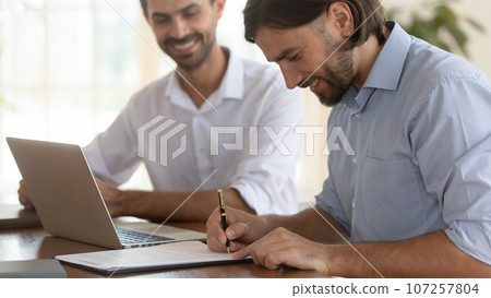 Two entrepreneurs making profitable deal concludes contract 107257804