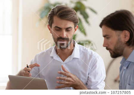 European confident executive manager makes presentation for client using notebook European confident executive manager makes presentation for client using notebook 107257805