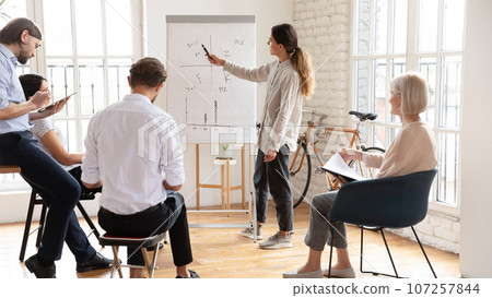 Busy diverse staff brainstorming taking part in seminar at boardroom 107257844
