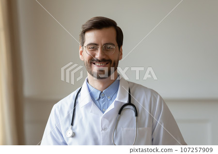 Head shot portrait smiling doctor wearing glasses looking at camera 107257909