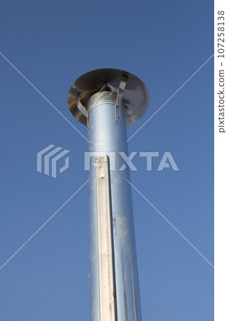 Metal chimney pipe on the roof of house Metal chimney pipe on the roof of house 107258138