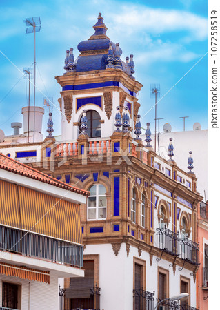 Old traditional tower with mosaics in the historical center of Seville. 107258519