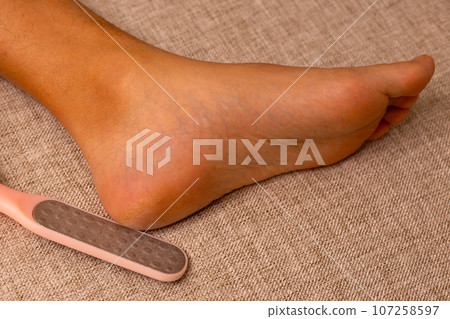 Foot with foot file, Cleansing the heel Foot with foot file, Cleansing the heel 107258597