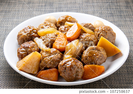 Sweet and sour pork-style meatballs with sweet and sour sauce. Sweet and sour pork-style meatballs with sweet and sour sauce. 107258637
