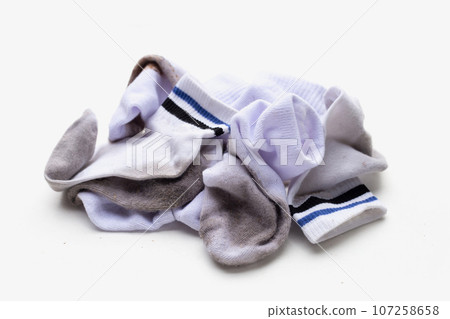 Dirty white socks on white background. 107258658