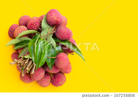 Lychee fruit on yellow background. 107258808