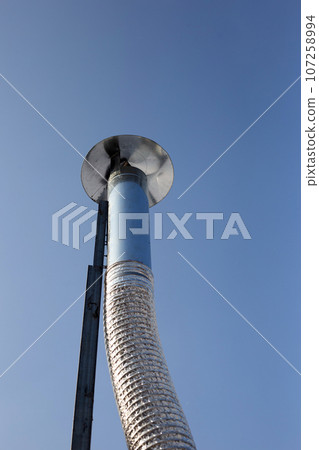 Metal chimney pipe on the roof of house Metal chimney pipe on the roof of house 107258994