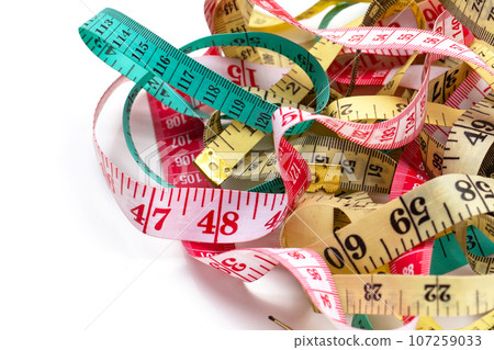 Measuring tapes on white background. 107259033