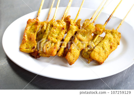 Grilled pork satay on white plate Grilled pork satay on white plate 107259129