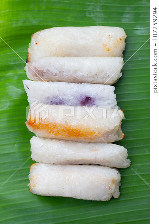 Grilled sticky rice in banana leaves with banana filling Grilled sticky rice in banana leaves with banana filling 107259294