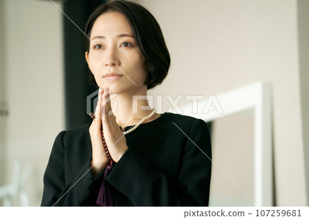 Photo of a woman attending a funeral Photo of a woman attending a funeral 107259681