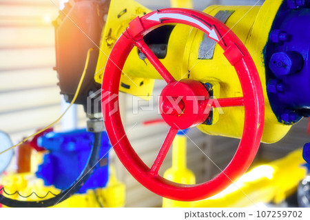 Industrial background. The gas pipeline is yellow with additional equipment, pipes and a valve for 107259702