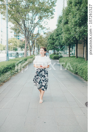 Photo of a young woman with a smartphone Photo of a young woman with a smartphone 107261527