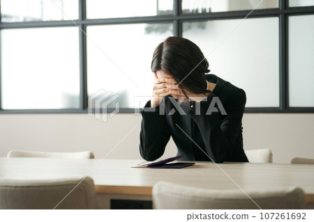 A sad woman in mourning clothes 107261692