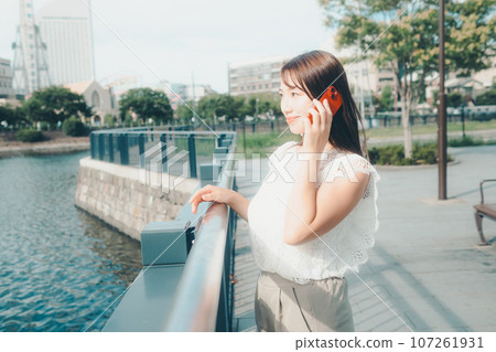 Photo of a young woman with a smartphone 107261931