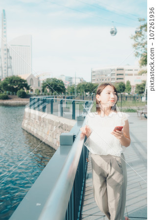 Photo of a young woman with a smartphone Photo of a young woman with a smartphone 107261936