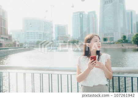 Photo of a young woman with a smartphone 107261942